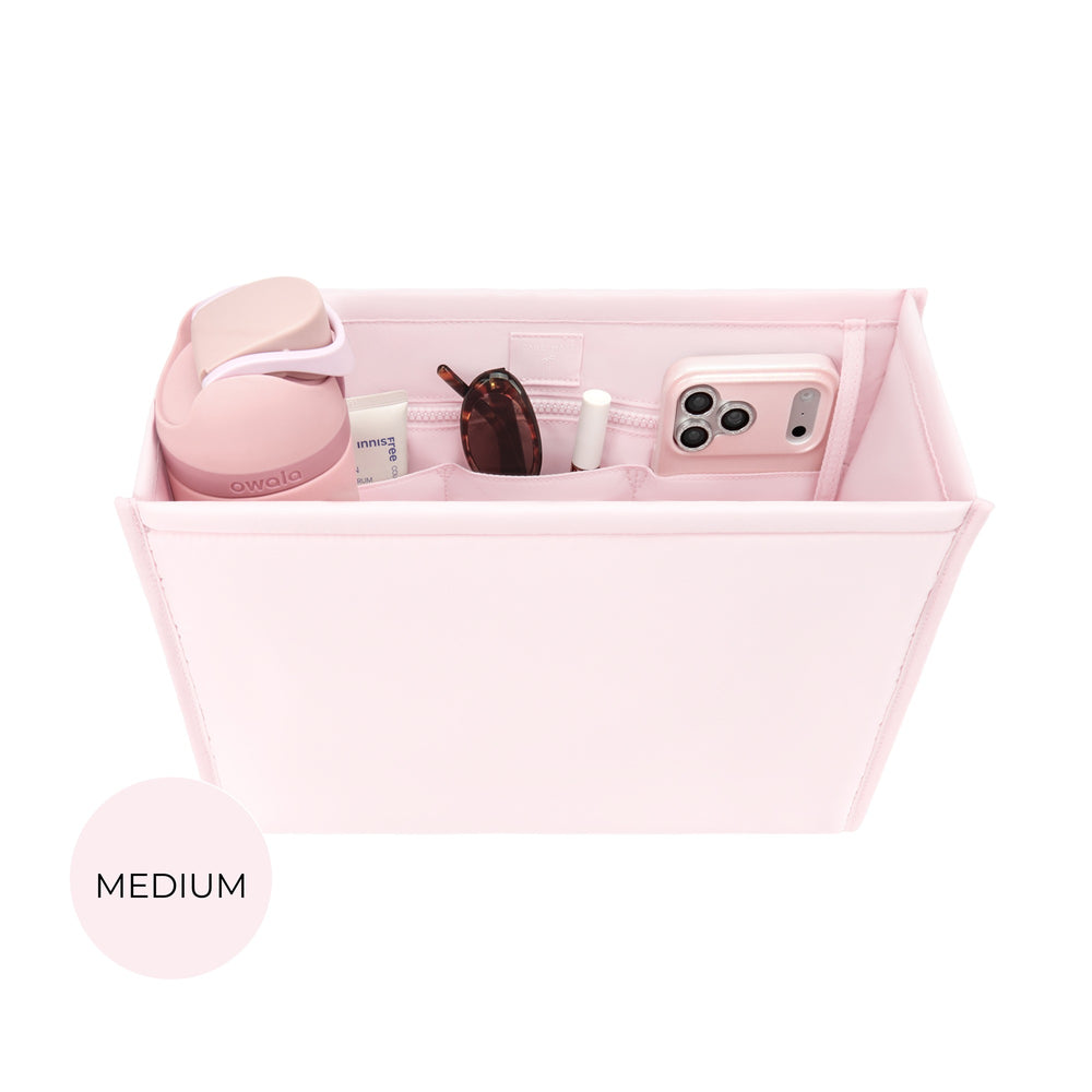Ballet pink medium tote organizer insert with compartments holding sunglasses, phone, and cosmetics
