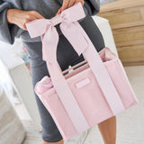 Woman holding pink tote organizer insert with bow handle detail