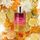 Juliette Has A Gun Magnolia Bliss Eau de Parfum bottle surrounded by citrus slices and flowers