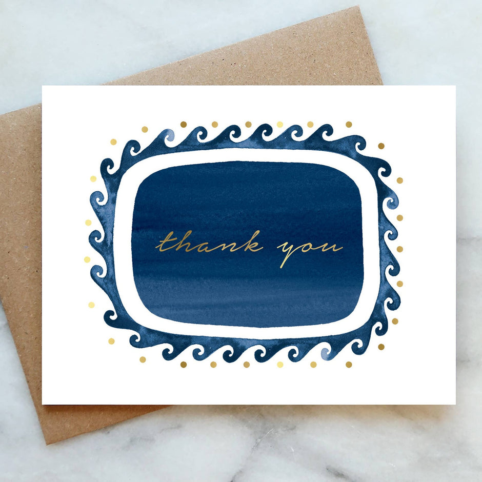 Elegant thank you greeting card with navy blue ornate frame and gold text on kraft envelope