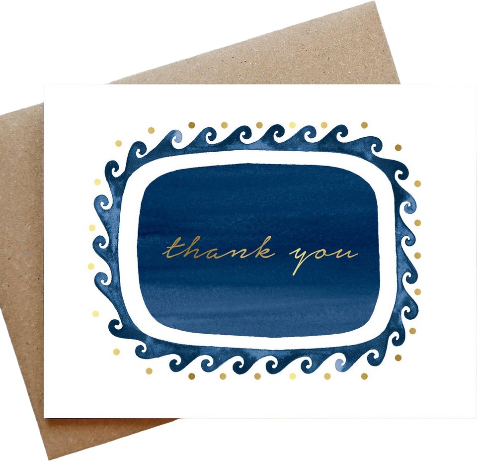 A square white greeting card with a decorative navy blue and gold border and the words 'thank you' in gold script, shown with a brown kraft envelope behind it on a white background.