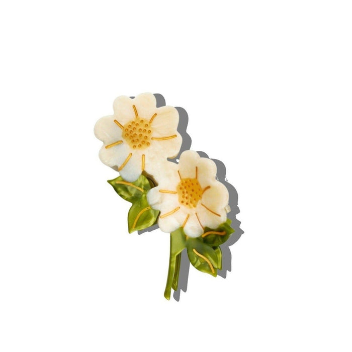 Hand-painted vintage daisy stem claw hair clip with white petals and golden center on white background