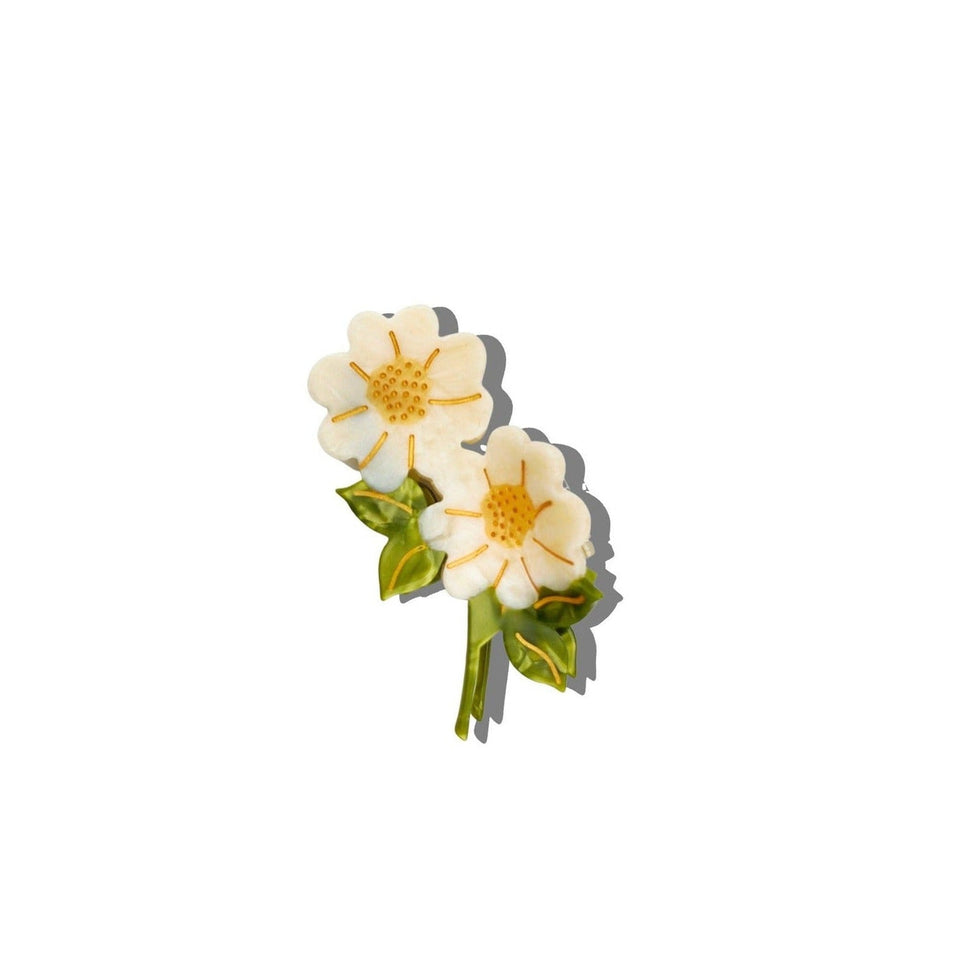 Hand-painted vintage daisy stem claw hair clip with white petals and golden center on white background