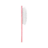 Pink eco-friendly Shih Tzu pup brush with white bristles on neutral background