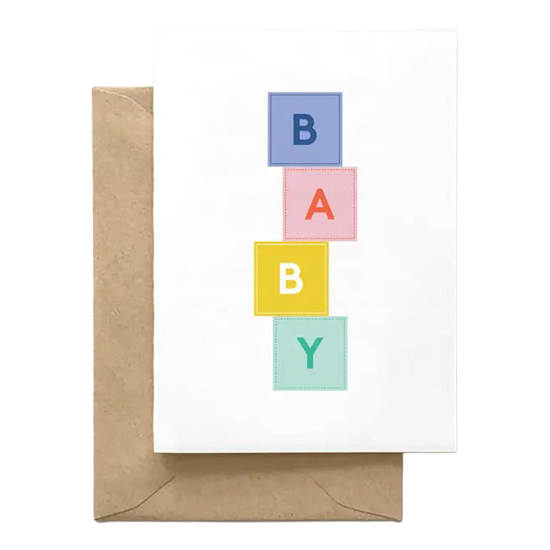 Greeting card with colorful 'BABY' blocks and a brown envelope on a white background