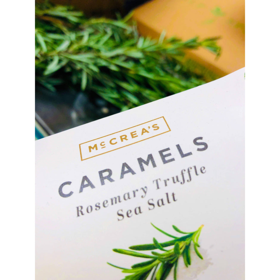 McCrea's Caramels Rosemary Truffle Sea Salt package with fresh rosemary herb styling