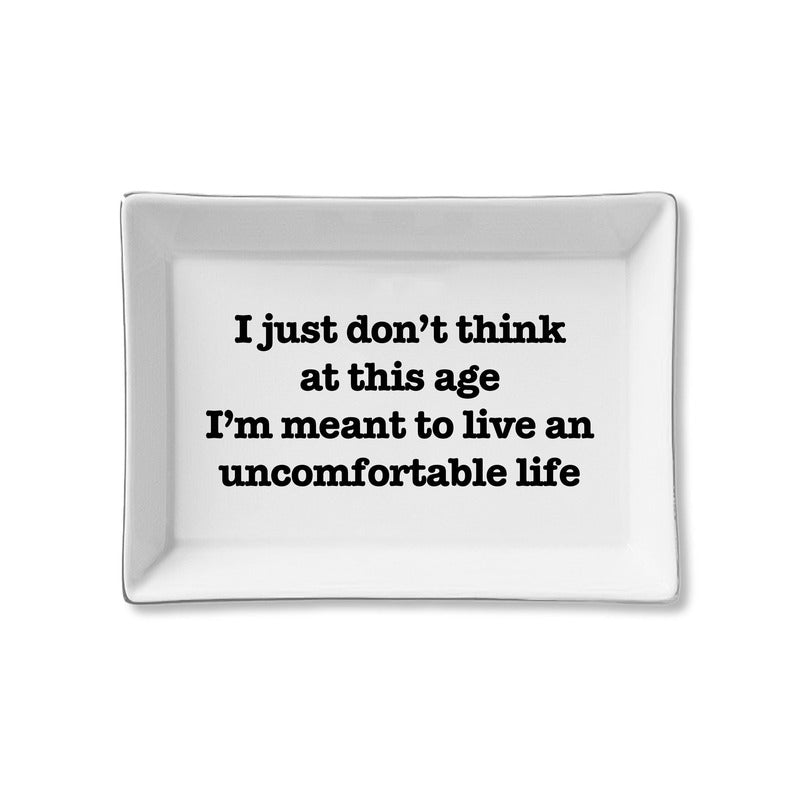 White ceramic tray with black text reading 'I just don't think at this age I'm meant to live an uncomfortable life'