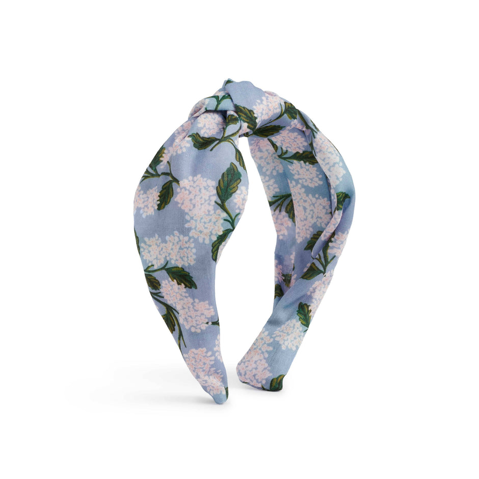Floral headband with blue and white flowers on a white background