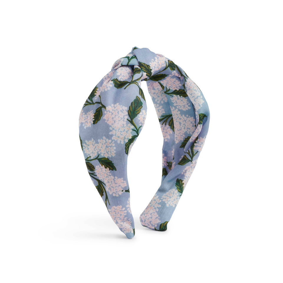 Floral headband with blue and white flowers on a white background