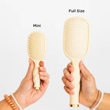 Mini vs Full Size Detangler Brush comparison showing tan hair brushes side by side