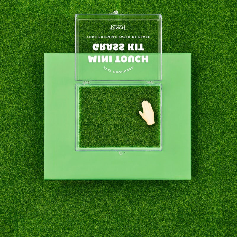 Pinch Provisions Mini Touch Grass Kit displayed on green background with hand touching moss