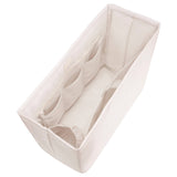 Cream-colored fabric tote organizer with multiple compartments and handles, shown from above