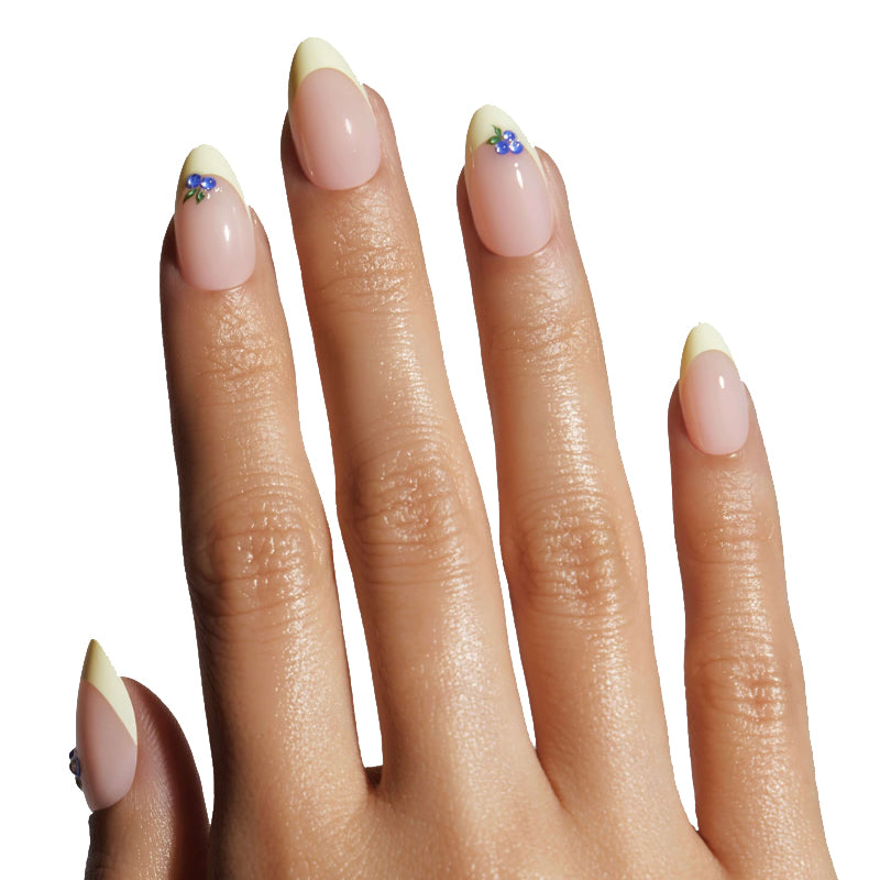 Close-up of a hand with beige nail polish on a white background