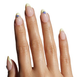 Close-up of a hand with beige nail polish on a white background