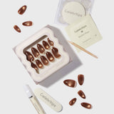 Cinnamon Powder Press On Nails by Celebritips - almond shaped bronze glitter nails with application kit