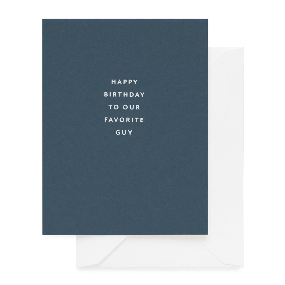 Blue birthday greeting card with white text saying 'Happy Birthday to Our Favorite Guy' with white envelope