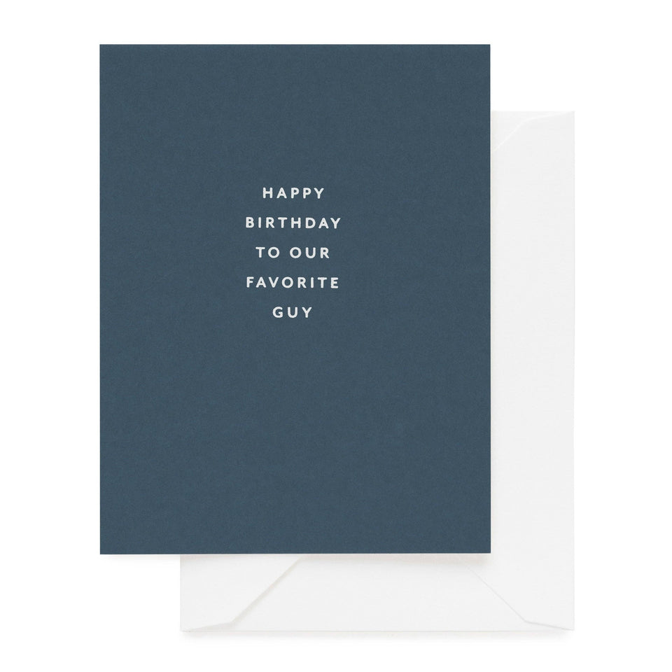 Blue birthday greeting card with white text saying 'Happy Birthday to Our Favorite Guy' with white envelope