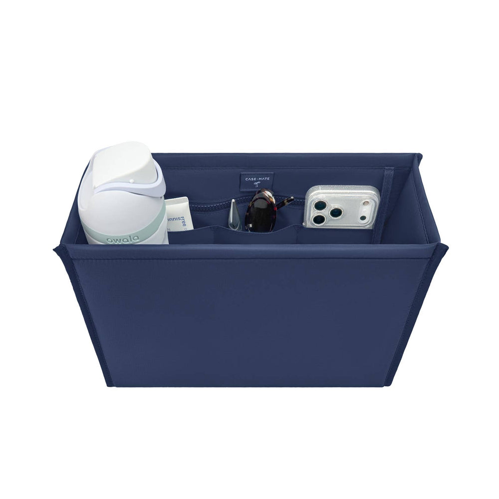 Case-Mate Oxford Navy tote organizer with white airpod case, sunglasses, phone case, and other accessories