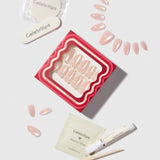 Celebritips press on nails in nude pink with crystal embellishments, shown with application kit