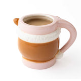 Pink ceramic mug with layered brown and cream design, filled with beverage