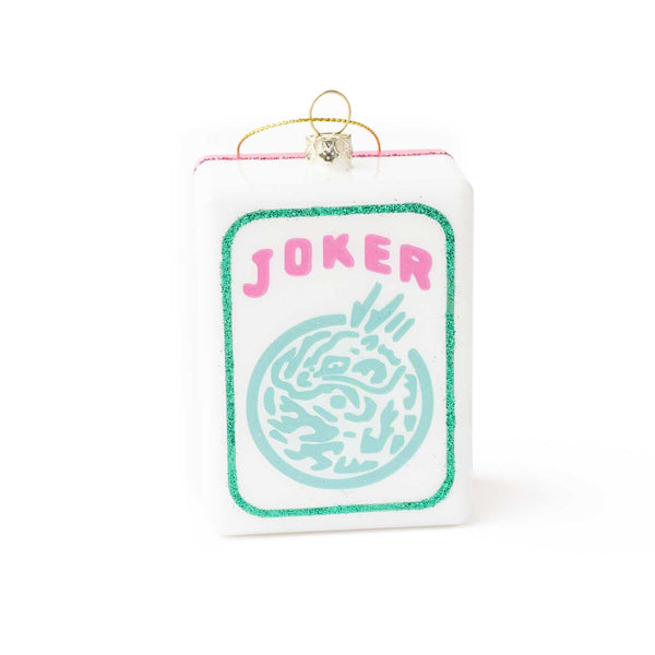 White glass ornament with 'JOKER' text and turquoise mahjong tile design, gold loop hanger