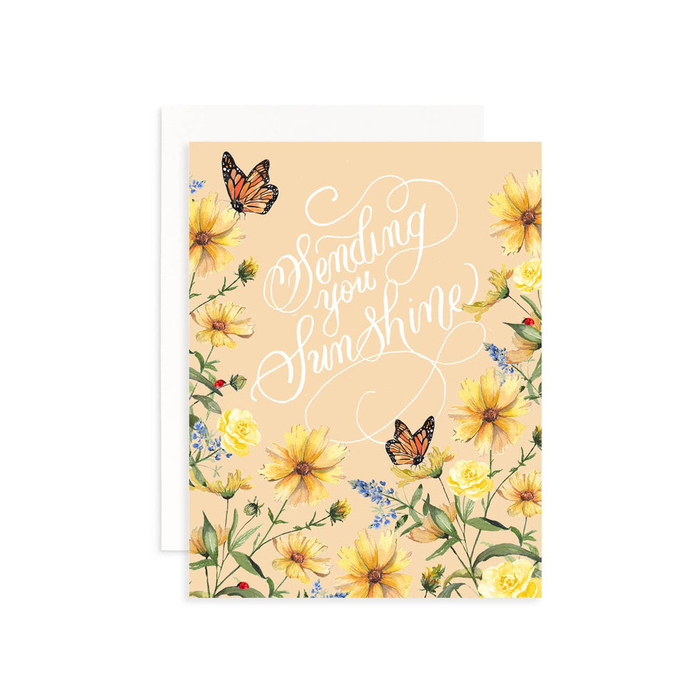 Greeting card with yellow flowers, butterflies, and 'Sending you sunshine' text on a beige background