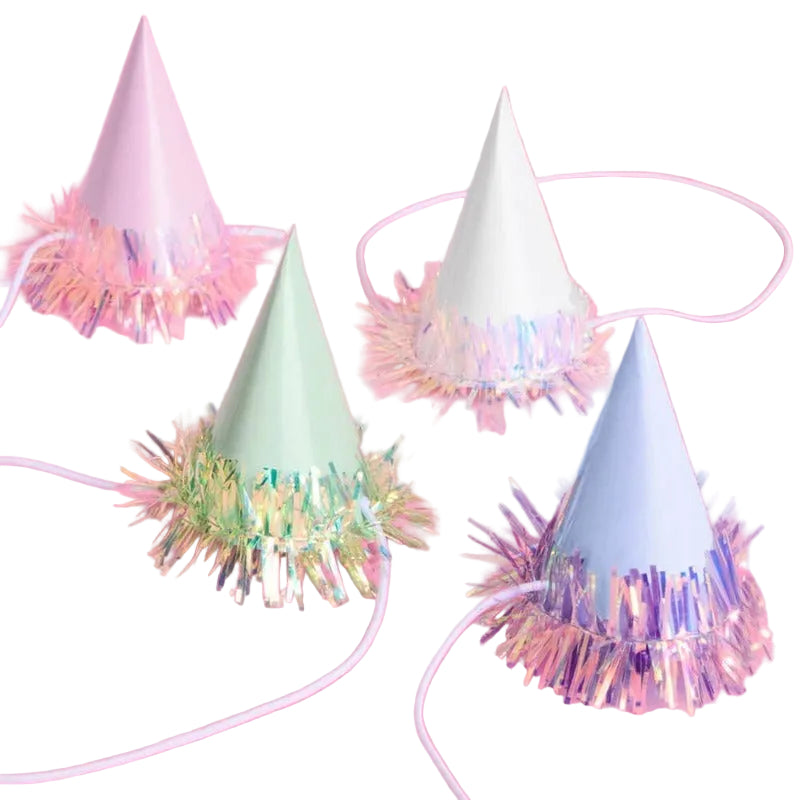 Iridescent mini party hats with colorful foil fringe skirts on pink background