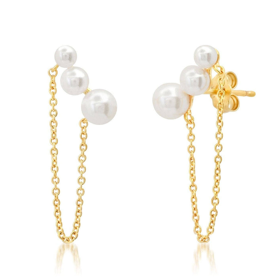 Gold pearl and chain stud earrings with white pearl accents on white background