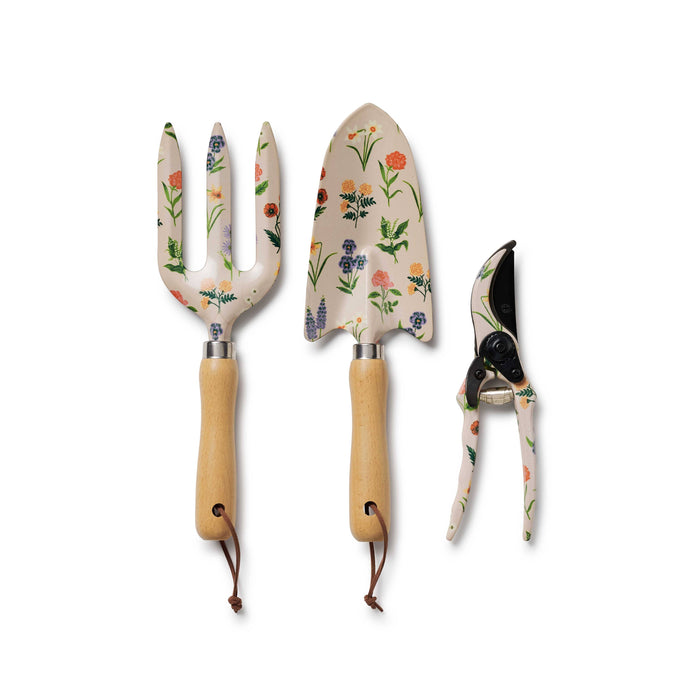 Set of three garden tools with floral handles on a white background