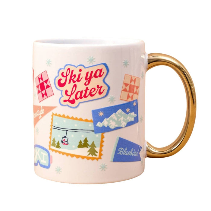 Ski Ya Later ceramic mug with gold handle featuring retro ski resort graphics and snowflake designs