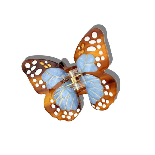 Solar Eclipse hand-painted boho monarch claw hair clip with blue and orange wings on white background