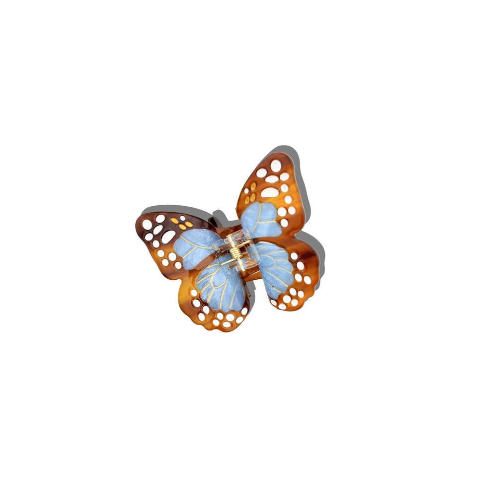 Solar Eclipse hand-painted boho monarch claw hair clip with blue and orange wings on white background