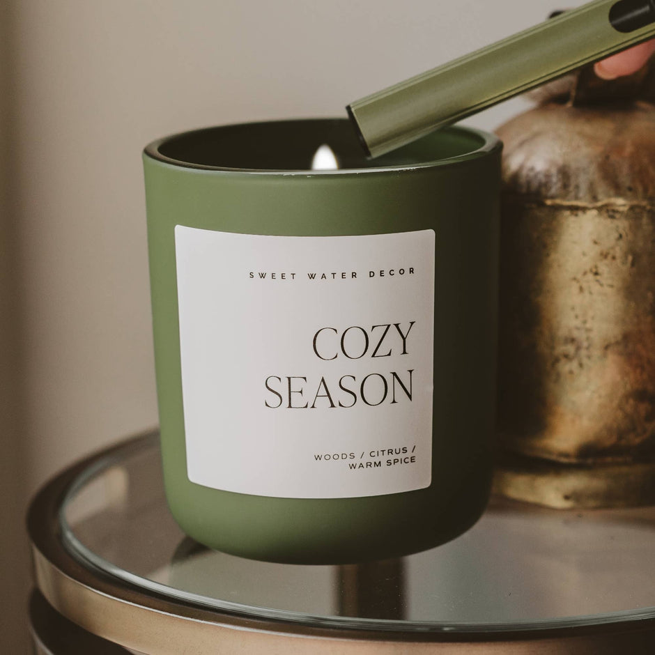 Cozy Season soy candle in matte green jar with wooden wick, styled home decor display