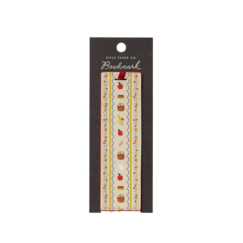 Rifle Paper Co. Schoolhouse bookmark with apple, basket, and pencil embroidered design on cream ribbon