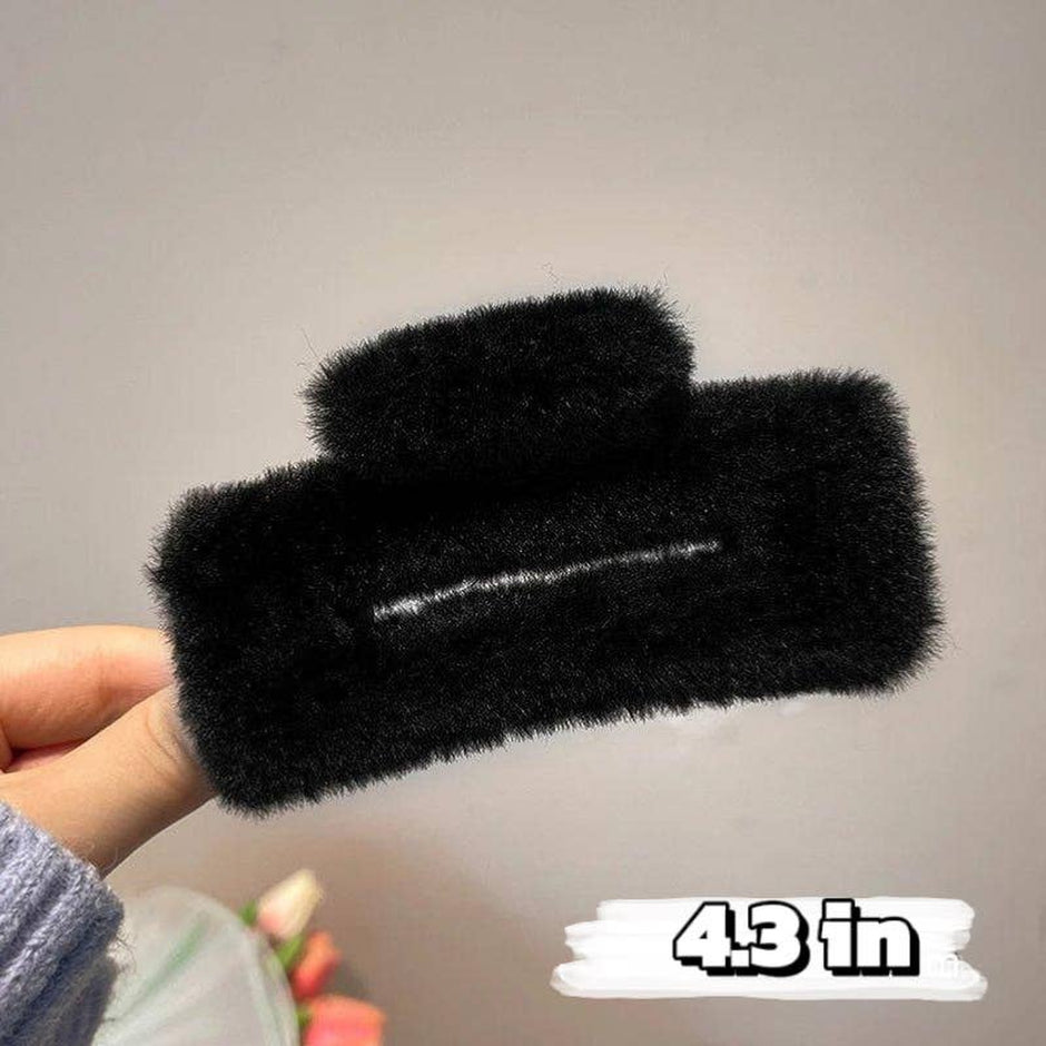 Black fuzzy knot cutout hair claw 4.3 inches held in hand with measurement label