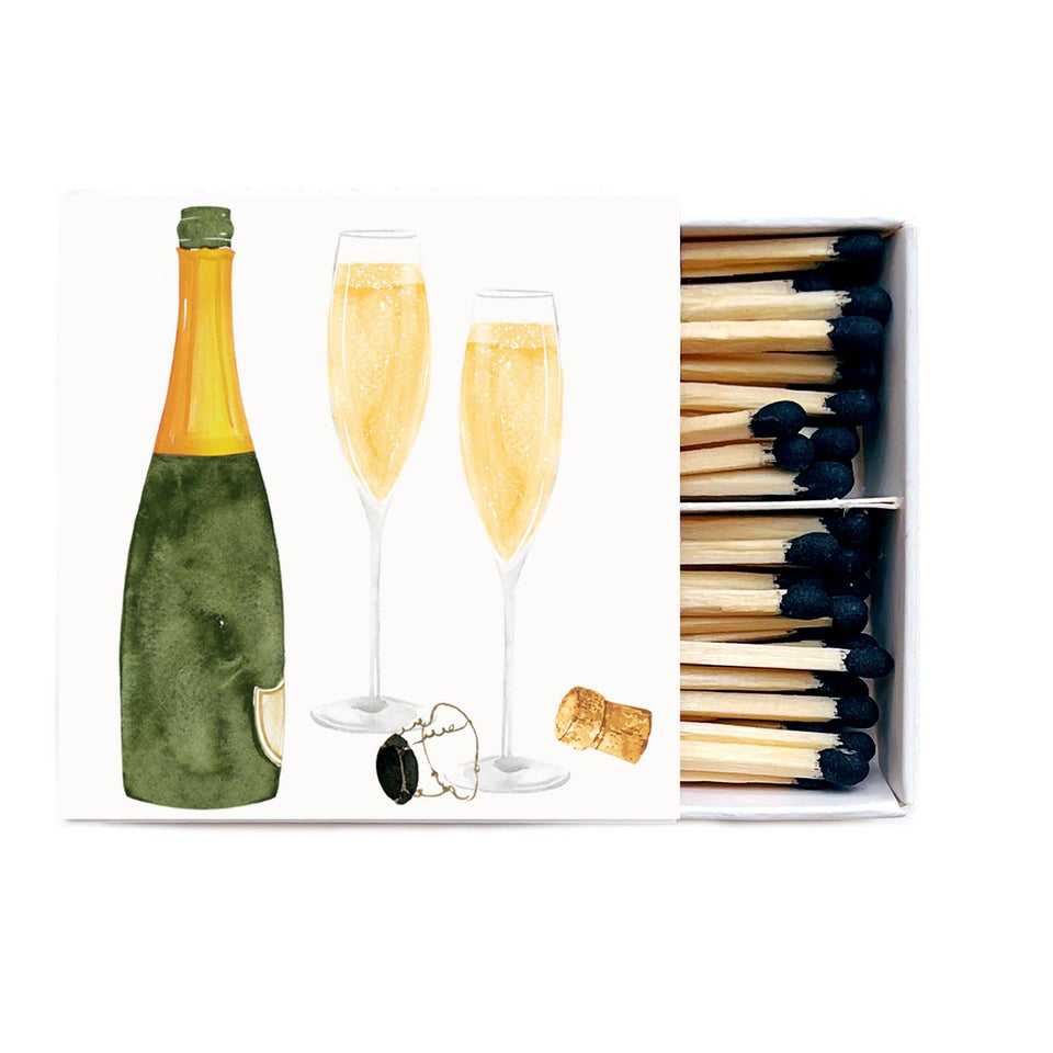 Champagne celebration matches with bottle, flutes, and cork on white background