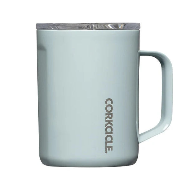 A light blue insulated mug with a clear lid and a vertical CORKICLE logo printed on the front, set against a plain white background.