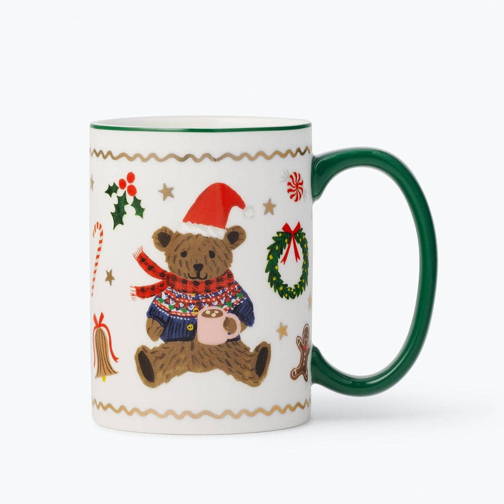 Green-handled porcelain mug with illustrated teddy bear wearing Santa hat and holiday decorations