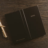 Black NOTES sticky notes booklet by Sweet Water Decor displayed with gold pen on wooden desk