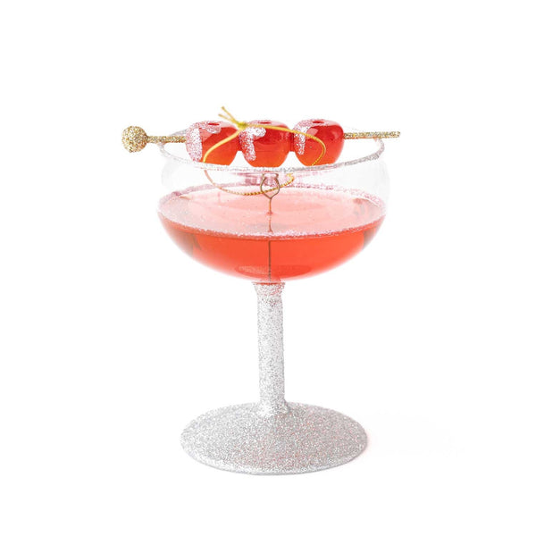 Glittery cocktail glass ornament with red candied apple garnish on gold stick