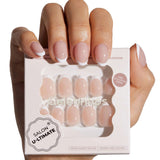 Model wearing Classic French press-on nails with white tips on natural short round shape