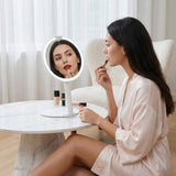 Woman applying red lipstick while looking at FANCII Abigail rechargeable travel mirror with LED light