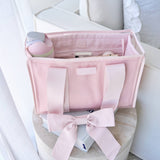 Ballet pink tote organizer insert displayed open on a chair, showing internal compartments and storage organization.