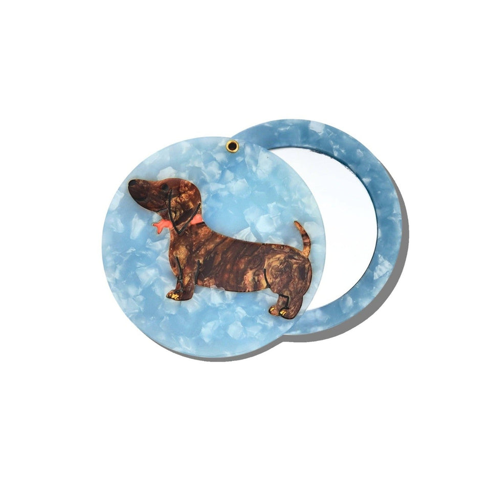 Solar Eclipse hand-painted dachshund compact mirror with light blue marbled design on white background