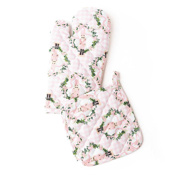 Sugarplum Gingham oven mitt set with pink gingham, nutcracker, and holly leaf pattern on white background