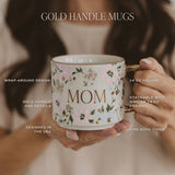 Gold handle mug with floral design held by model showing product features and specifications