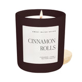 Sweet Water Decor Cinnamon Rolls 15 oz soy candle in matte dark brown jar with lit flame