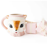 Pink ceramic reindeer mug with knit collar and matching gift boxes on white background