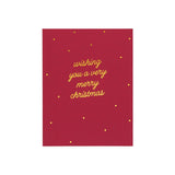 Red Christmas card with gold cursive text reading 'wishing you a very merry christmas' and gold dots