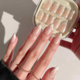 Hand with manicured nails holding a container of false nails.